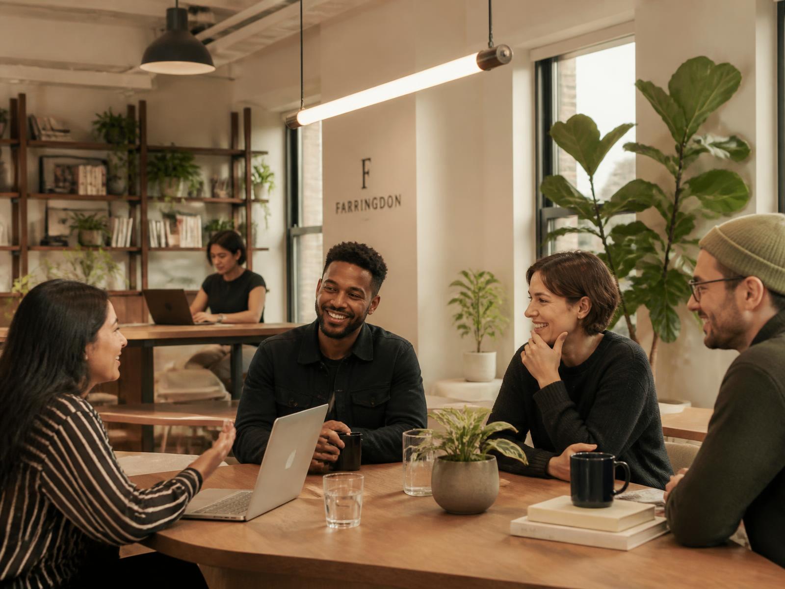 Colleagues collaborating around a table in a bright, welcoming London startup office